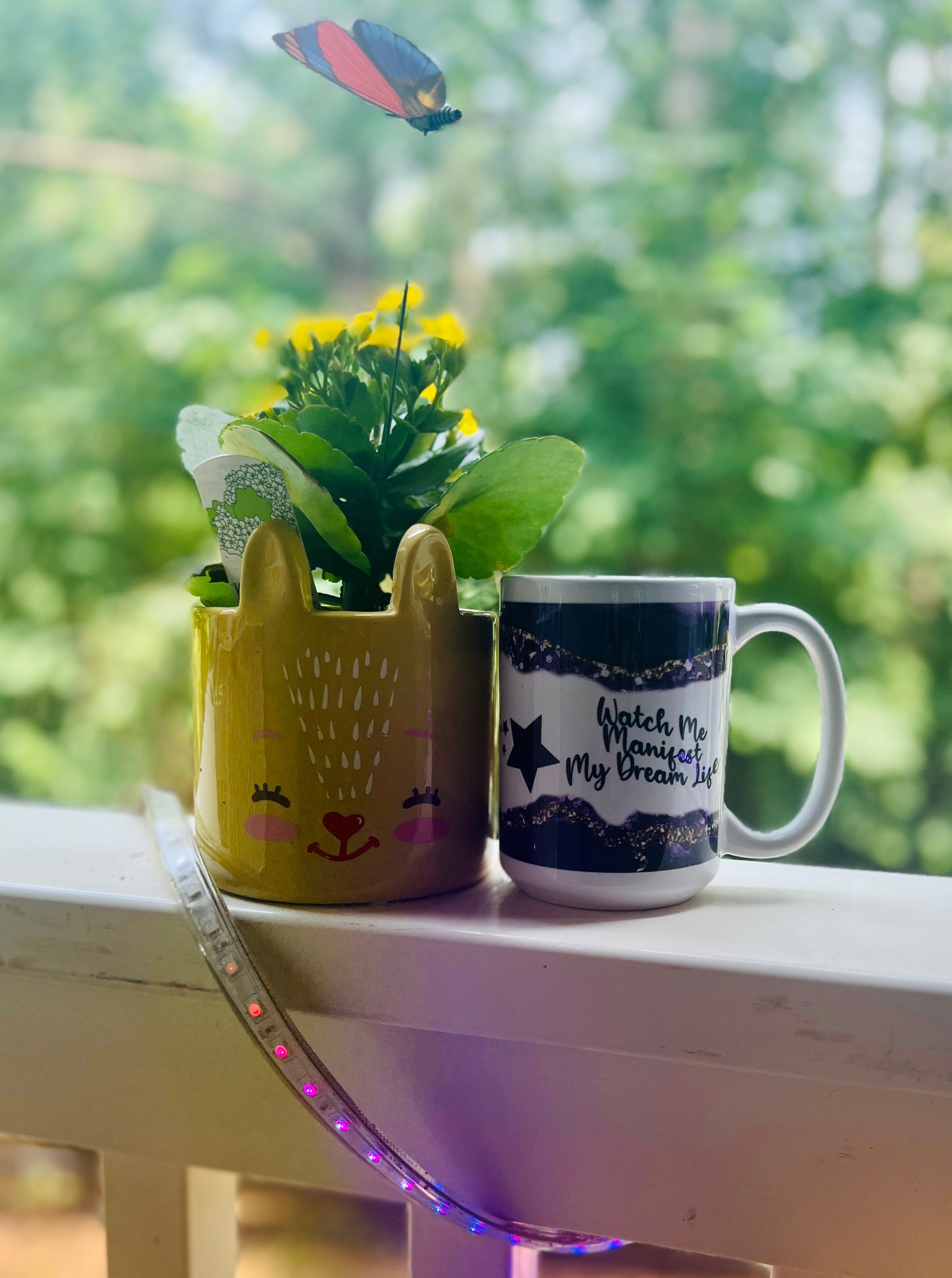 15 oz coffee mug with the quotes: 'Be the extra in the ordinary' on one side and 'Watch me Manifest my Dream Life' on the other with a Purple and gold design on top and bottom..